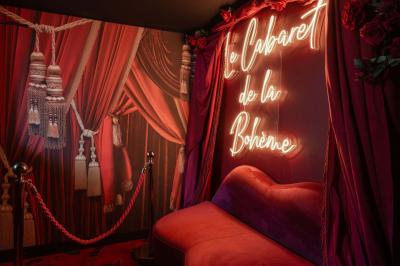 Quatre verres à vin alignés sur une table en marbre noir, avec un photophore rouge et des couverts à proximité.