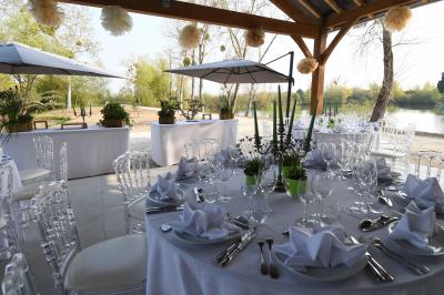 Vue aérienne d'un parc avec plusieurs étangs, espaces verts, chemins et bâtiments entourés de végétation.