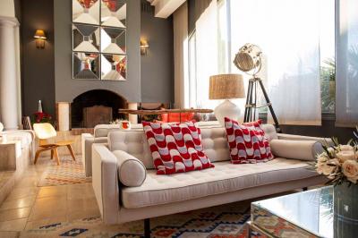 Intérieur d'un salon moderne avec un bureau blanc, des étagères éclairées, des décorations élégantes et un coin salon.