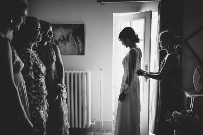 Des personnes en tenue élégante regardent des danseuses en maillot de bain et bonnet, lors d'un événement en extérieur.