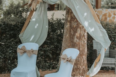 Étang calme entouré d'arbres avec un paysage vallonné en arrière-plan sous une lumière naturelle.