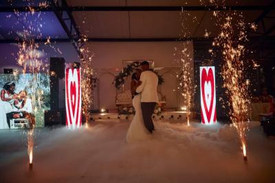 Un DJ portant un casque audio mixe sur son équipement dans un environnement sombre.