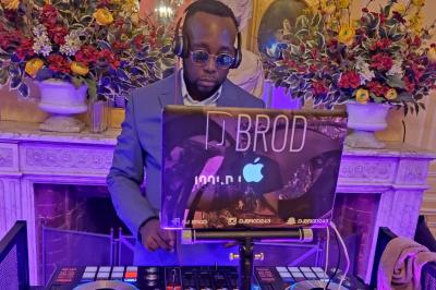 Groupe de musiciens sur scène avec éclairages colorés et écran lumineux en arrière-plan dans une salle de spectacle.