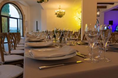 Vue aérienne d'une maison en pierre avec toit en tuiles, entourée d'arbres, d'une piscine et d'un chemin en gravier.