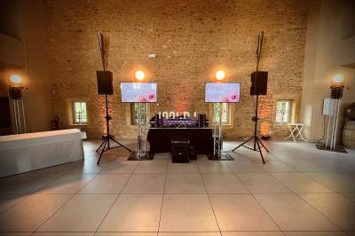 Foule dansant sous des jeux de lumière colorés lors d'une soirée festive en intérieur.