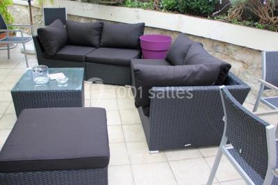 Cuisine moderne avec meubles laqués gris, plan de travail clair, micro-ondes et éclairage intégré.