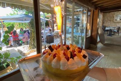 Deux gâteaux aux fraises et oranges décorés de chocolat, avec une tuile aux amandes en arrière-plan.