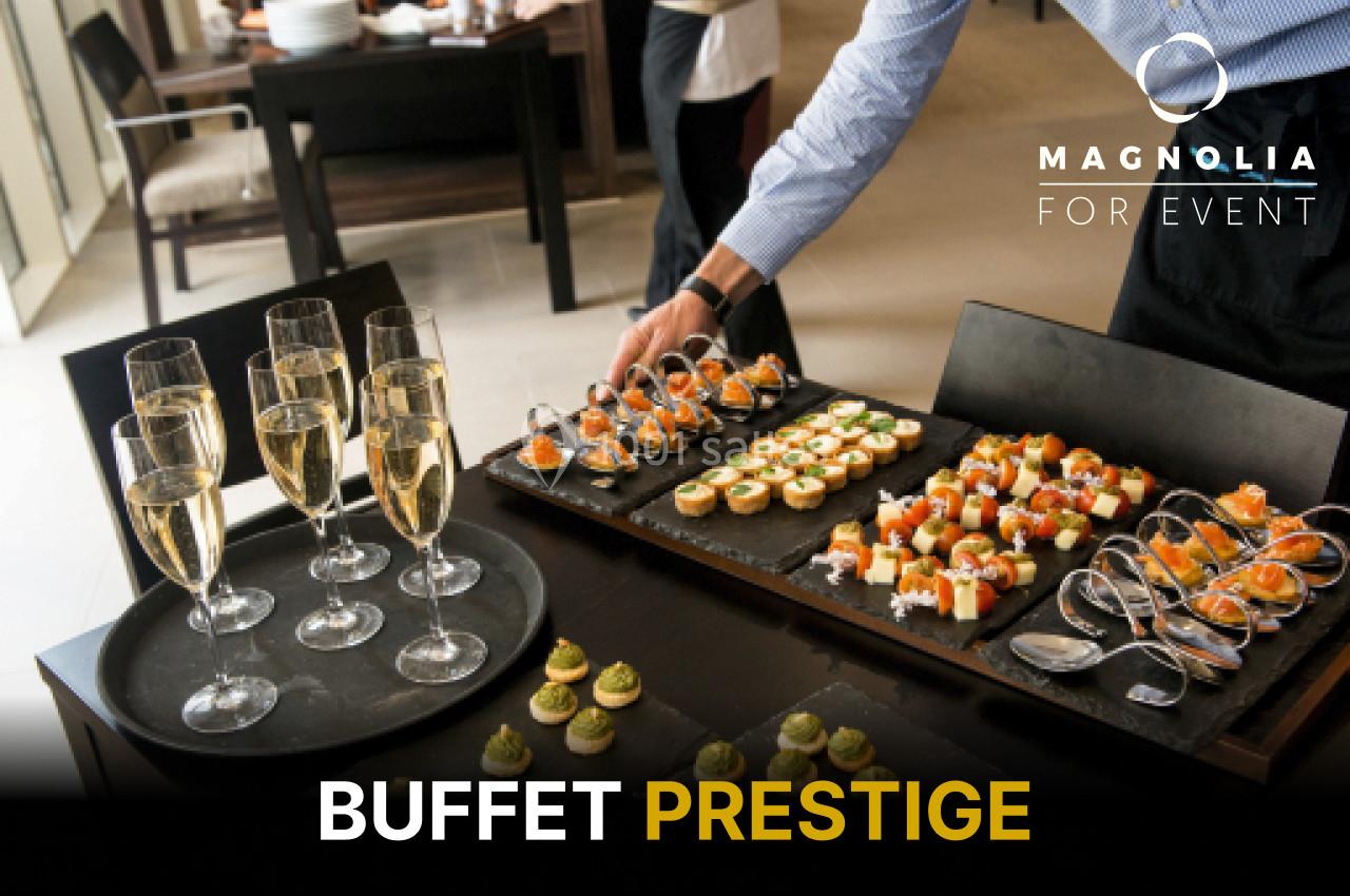 Plateau de bouchées salées et flûtes de champagne disposés sur une table pour un buffet élégant.
