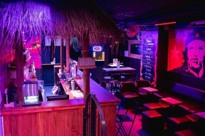 Écran de projection affichant une image d'intérieur coloré dans un espace sombre avec sièges et éclairage néon.