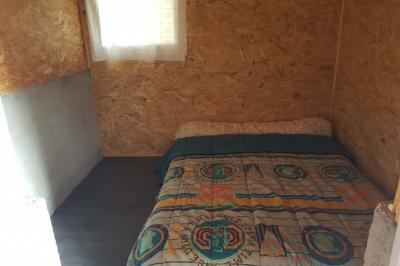 Coin salon avec canapé, fauteuils en cuir, table basse avec jeu d'échecs, bibliothèque et décorations murales.