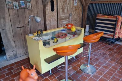 Coin salon avec canapé, fauteuils en cuir, table basse avec jeu d'échecs, bibliothèque et décorations murales.