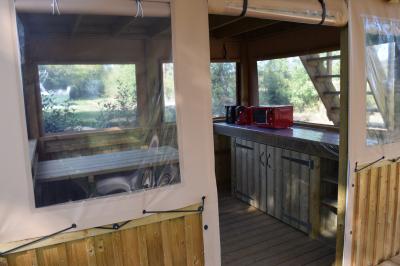 Espace de détente avec canapé, fauteuils, table basse avec échiquier, bibliothèque et décorations murales.