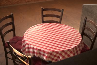 Espace de détente avec canapé, fauteuils, table basse avec échiquier, bibliothèque et décorations murales.