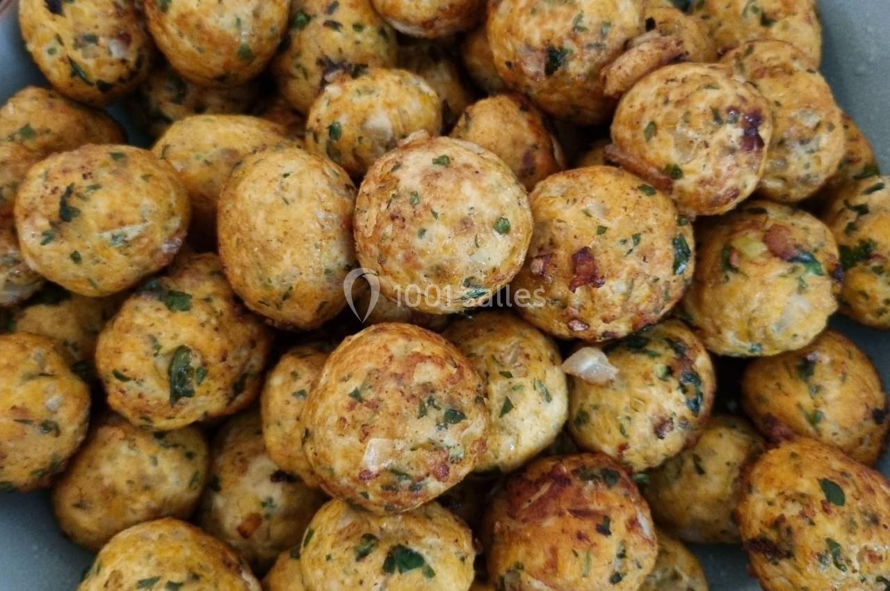 Boulettes dorées aux herbes servies dans un bol, probablement préparées à base de légumes ou de légumineuses.