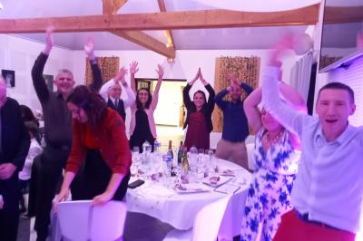 Salle de réception avec tables dressées, vue depuis une scène équipée d'une console de mixage lumineuse.