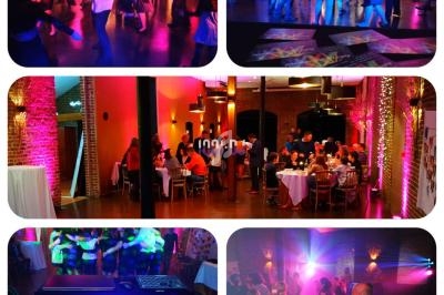 Personnes dansant et dînant dans une salle éclairée par des lumières colorées, avec une table de mixage au premier plan.