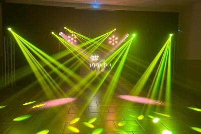 Jeux de lumières jaunes et roses projetés dans une salle sombre avec un sol carrelé.