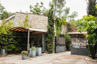 Salle de réception décorée avec des guirlandes lumineuses, des lanternes suspendues et des tables dressées pour un événement.