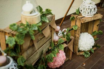 Salle de réception lumineuse avec des tables rondes dressées, nappes blanches et chaises rouges.