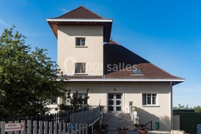 Assortiment de tartinades dans des bols blancs posés sur une rondelle de bois, avec des amuse-bouches en arrière-plan.