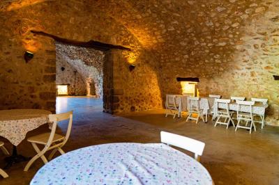 Vue sur un lac entouré de collines verdoyantes à travers une fenêtre ouverte avec des volets en bois.