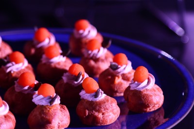 Tunnel d'aquarium avec un grand bassin à droite, éclairages colorés et écran lumineux sur le mur gauche.