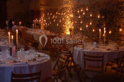 Deux lits simples avec couvertures vertes dans une chambre mansardée aux poutres apparentes et murs en plâtre.