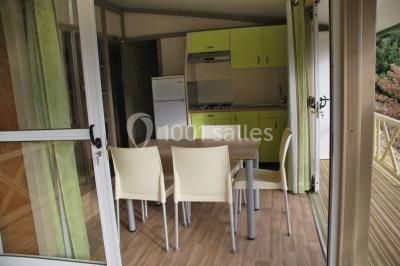 Vue aérienne d'un complexe avec piscine, toboggan aquatique, mini-golf et espaces ombragés entourés de végétation.