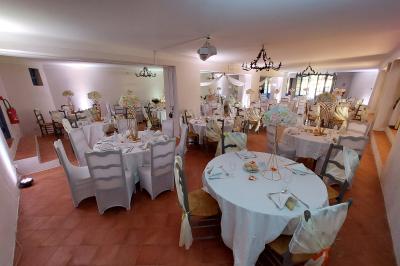 Table dressée pour un repas avec nappes blanches, couverts, verres, menus, pains, bouteille de vin et seau à glace.