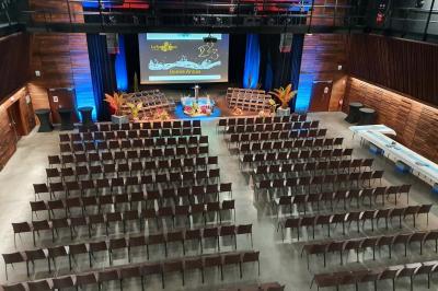 Miniature Salle Ebène Accueil avec comptoir blanc, porte-manteaux en arrière-plan, grande baie vitrée et plante verte à droite.