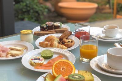 Escalier intérieur avec rampe en fer forgé, miroir mural, appliques dorées et fresque artistique sur le mur.