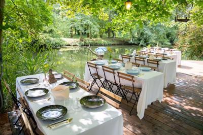 Tables dressées avec nappes blanches, vaisselle élégante, verres à pied et décorations florales sous des tonnelles…