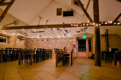 Vue d'un bar rustique en pierre et bois avec éclairage suspendu dans une pièce au style traditionnel.