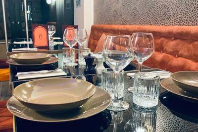 Table garnie de desserts variés, incluant une pièce montée, des verrines et des pâtisseries, dans un cadre tamisé.