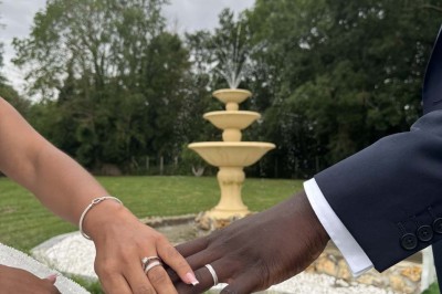 Table élégamment dressée avec vaisselle raffinée, centre de table floral et décoration lumineuse en arrière-plan.