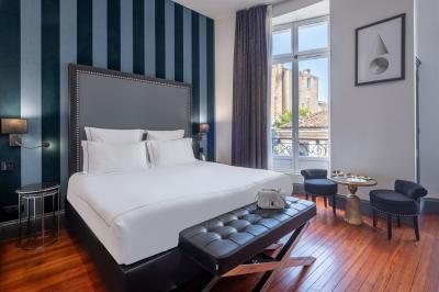 Salle de massage avec table recouverte de serviettes, éclairage tamisé et bougies pour une ambiance relaxante.