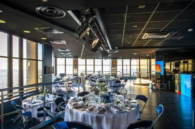 Vue aérienne de Paris au crépuscule, avec la tour Eiffel illuminée et les Invalides visibles au premier plan.