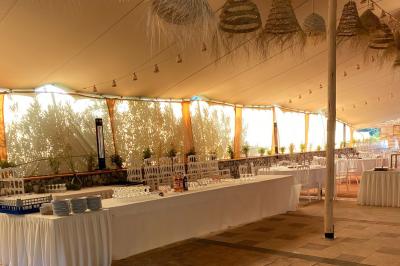 Statue en pierre représentant une femme dans un jardin avec des pots en terre cuite et une allée pavée en arrière-plan.