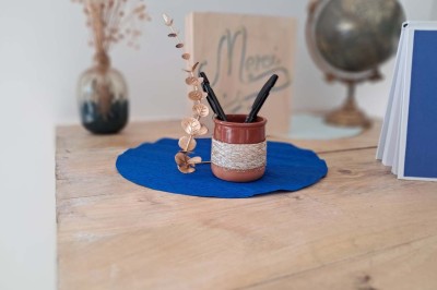 Comptoirs en bois avec décorations florales, installés en extérieur sous un ciel dégagé près de bâtiments modernes.