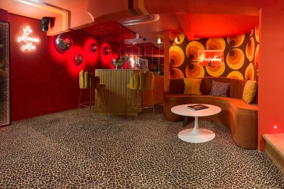 Miniature Location salle Paris 12 (Paris) - L'Olivia #119 Platine vinyle sur un meuble en bois, plante en pot et lampes dans une pièce aux tons rouges et orange.