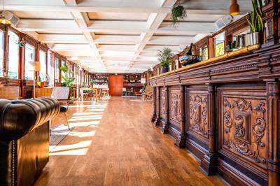 Panneau en bois indiquant les directions vers un jardin d'hiver et un boulodrome, entouré de verdure.