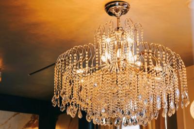 Un comptoir décoratif avec des objets design, éclairé par une lumière chaleureuse et entouré de rideaux blancs.