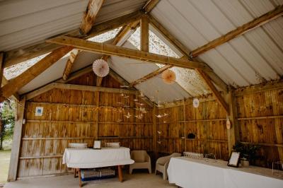 Cuisine professionnelle équipée avec plaques de cuisson, étagères, réfrigérateur, évier et équipements de sécurité visibles.