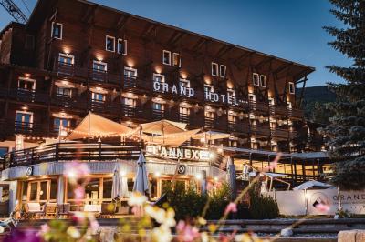 Logo du Grand Hôtel Serre Chevalier avec un dessin stylisé de montagne en noir et blanc.