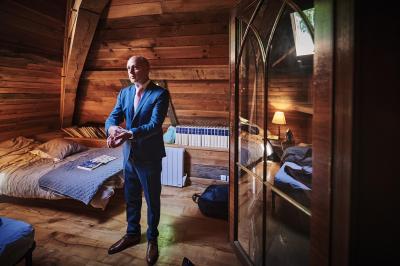 Un grand groupe de personnes souriantes levant les bras, rassemblées dans un parc pour une célébration.