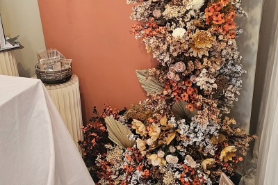 Miniature Merveilleux Moments #13 Présentoir en bois décoré de fleurs et de choux colorés, lors d'une célébration en extérieur.