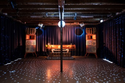 Vue plongeante sur des structures d'ombrage en toile beige et en fibres naturelles dans un espace extérieur aménagé.