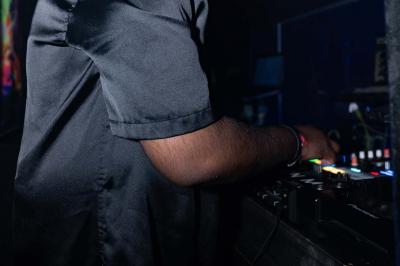 Façade d'un club nocturne avec enseigne lumineuse ’Infinity Club’ et porte ornée de motifs décoratifs.