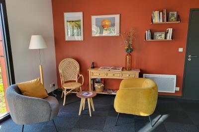 Vue aérienne d'une campagne verdoyante avec champs, haies, étangs et un village sous un ciel bleu dégagé.