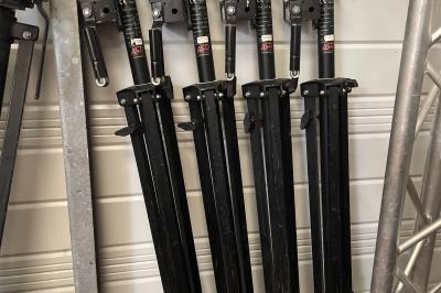 Enceintes de sonorisation empilées dans une configuration de type line array, partiellement couvertes par des housses.